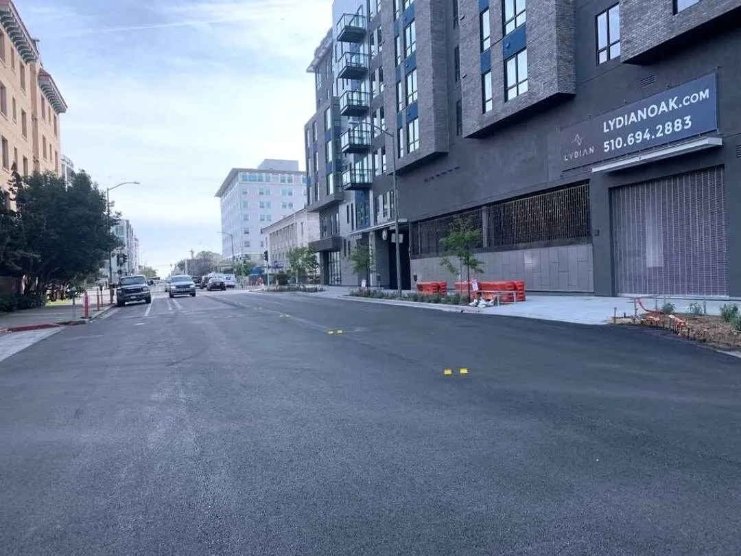 A freshly repaved downtown Oakland street running past the Lydian apartment building at 226 13th Street.