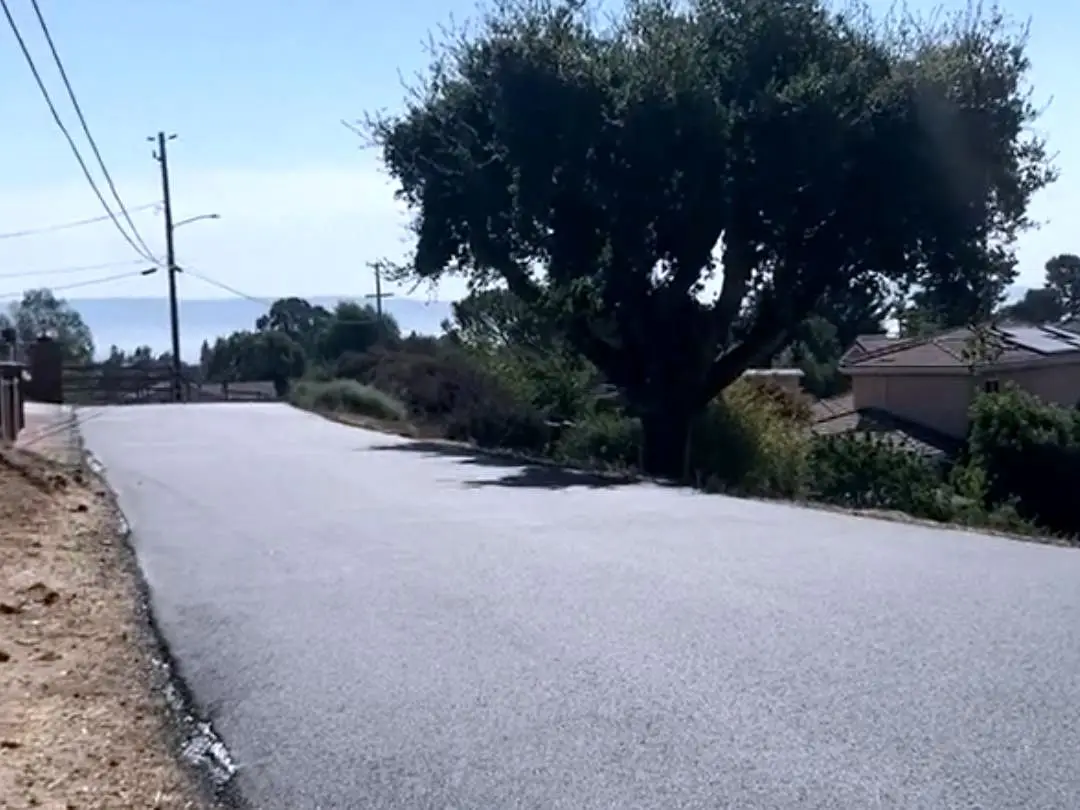 A newly repaved residential street in the Hayward Hills, dropping away towards the bay.