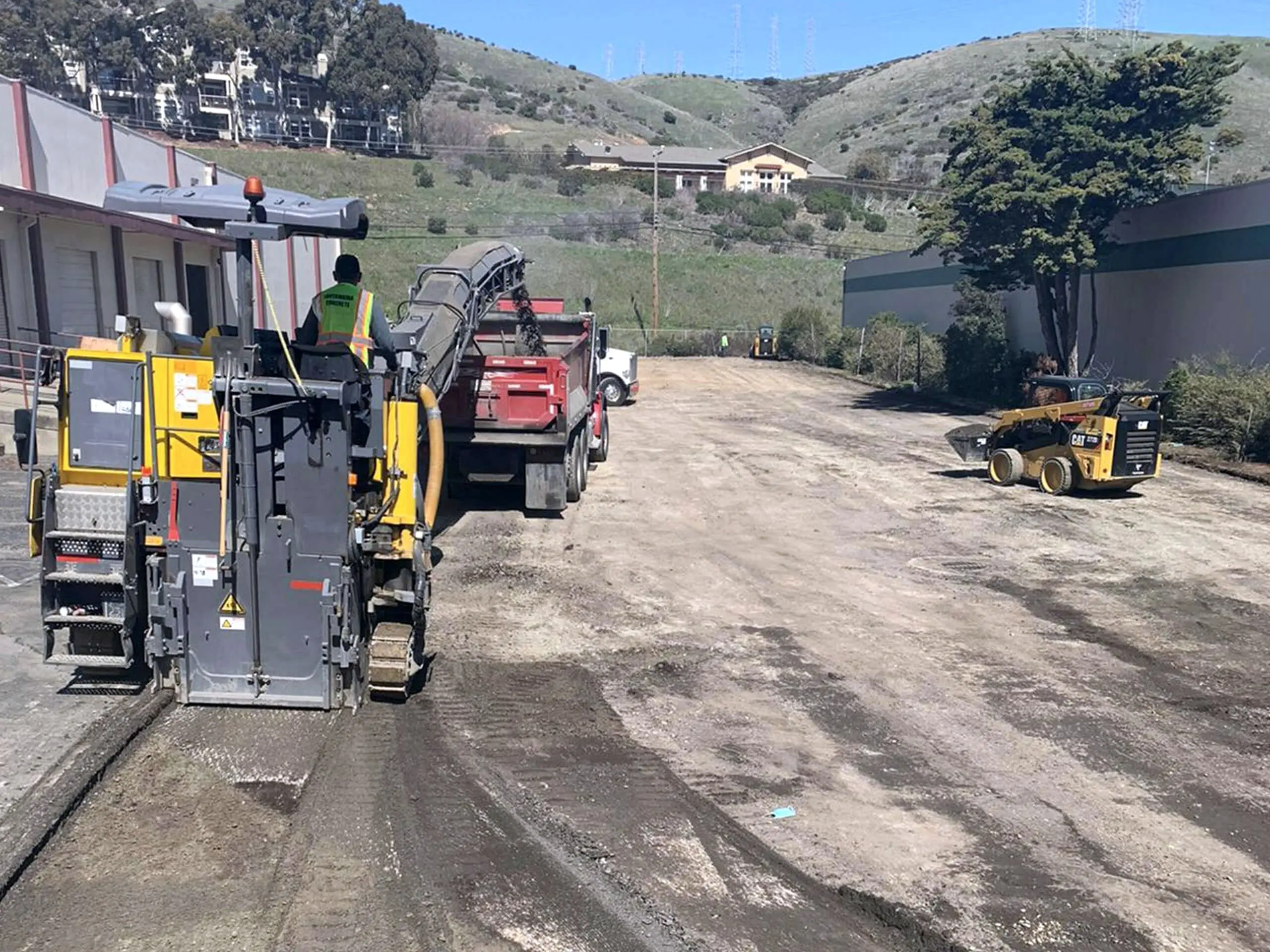 A milling machine discharging grindings into a dump truck at 460 Valley Drive, Brisbane.