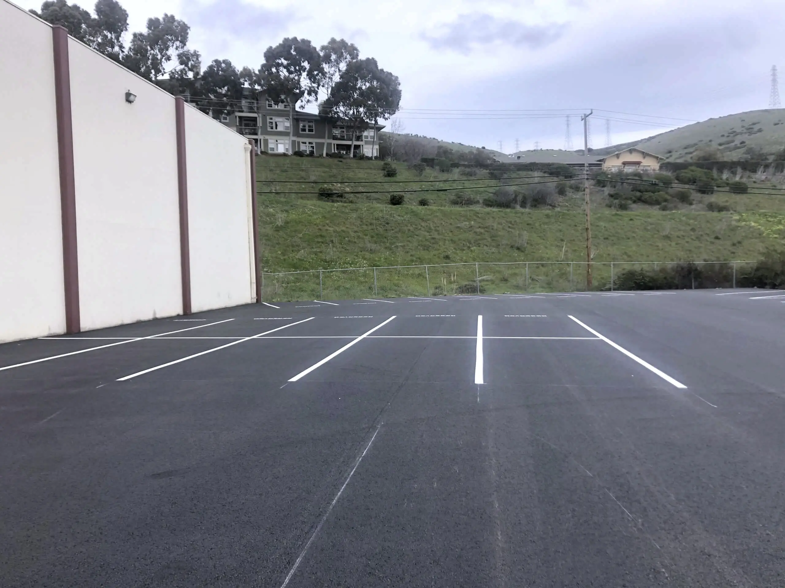 The finished parking field at 460 Valley Drive, striped and open, with the Brisbane hills behind.