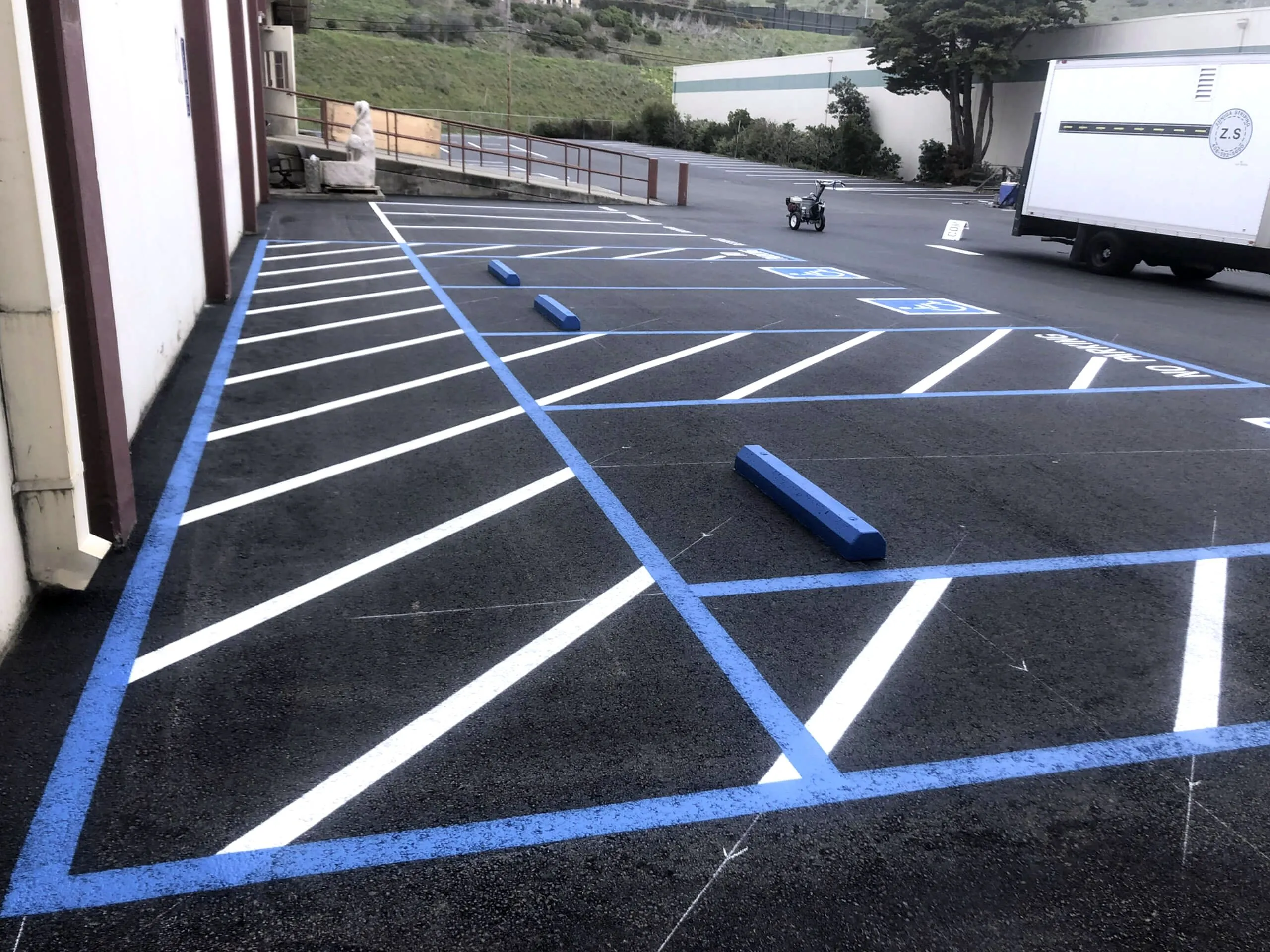 The completed parking area at Bay Medical Co. in Brisbane, with fresh white stall striping and a blue accessible stall and access aisle.