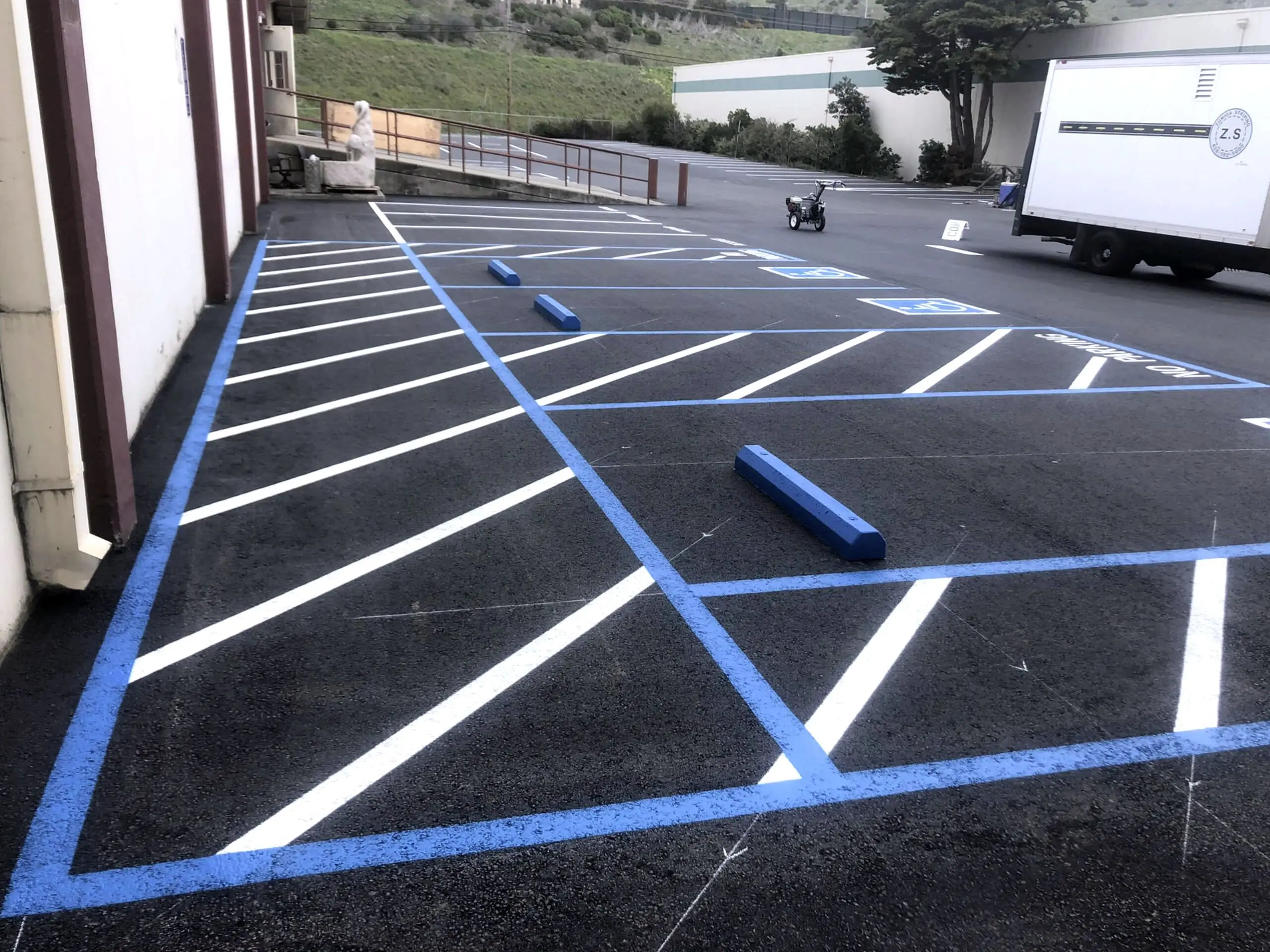 The completed parking area at Bay Medical Co. in Brisbane, with fresh white stall striping and a blue accessible stall and access aisle.