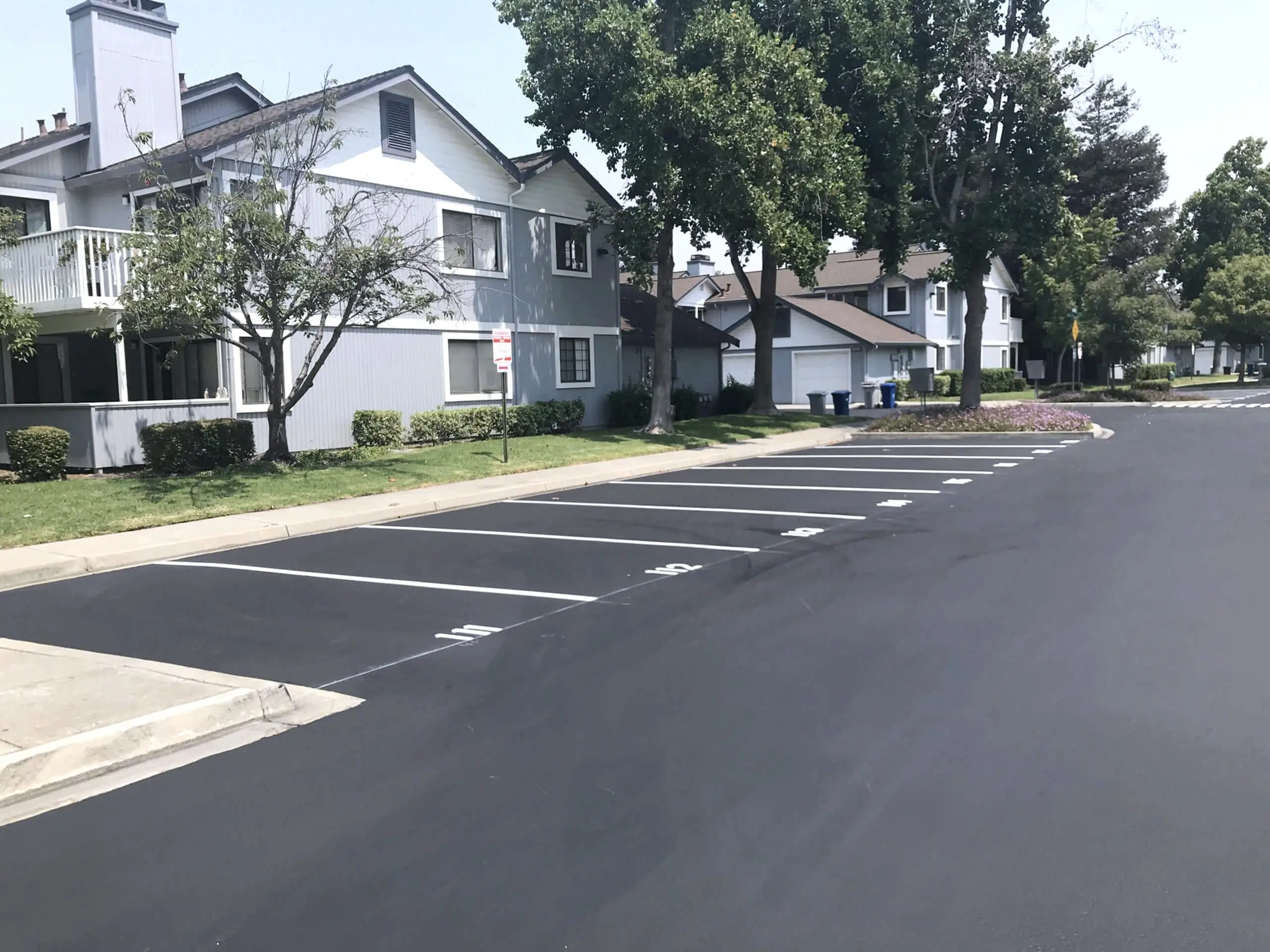Newly striped resident parking stalls in front of townhomes at The Crossings HOA, Fremont.